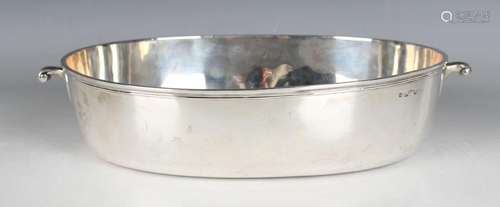 A George III silver oval bowl with scroll handles and reeded...