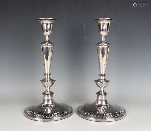 A pair of George III silver candlesticks with fluted decorat...