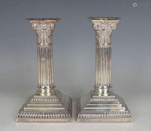 A pair of Edwardian silver Corinthian column candlesticks