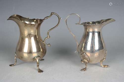 A George V silver baluster cream jug with scroll handle