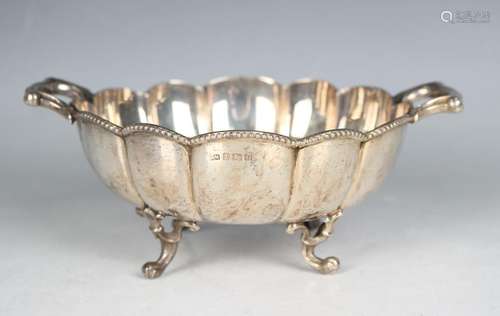 A George V silver circular lobed twin scroll handled bowl wi...