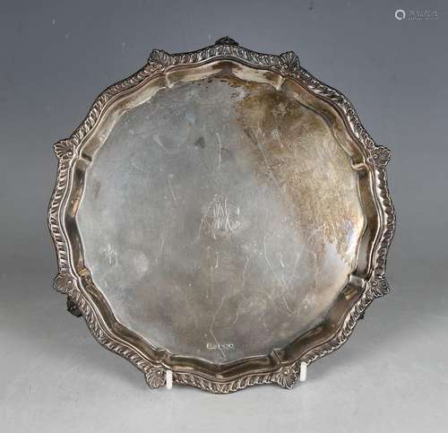 A George V silver circular card salver with leaf and gadroon...