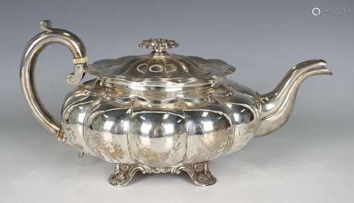 A George IV silver teapot of squat circular lobed form with ...