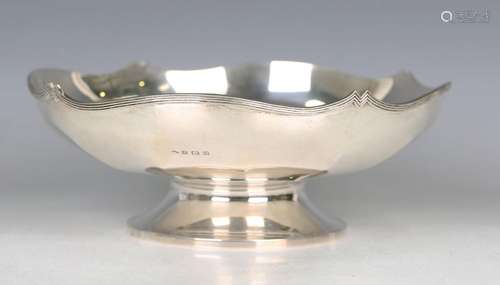 A George V silver footed bowl of faceted circular form with ...