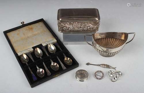 A late Victorian silver oval half reeded two-handled sugar b...