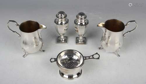 A pair of Elizabeth II silver baluster cream jugs