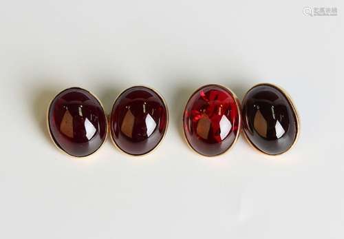 A pair of gold and oval carbuncle garnet cufflinks