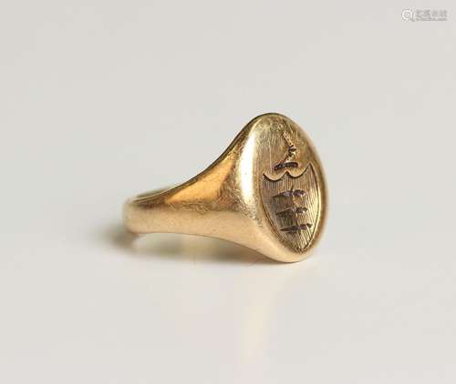 A gold oval signet ring