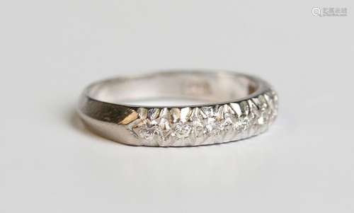 A white gold and diamond eight stone half eternity ring