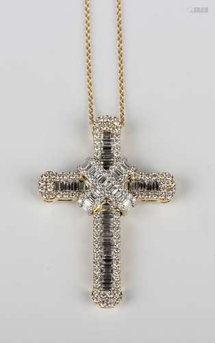 A gold and diamond pendant cross