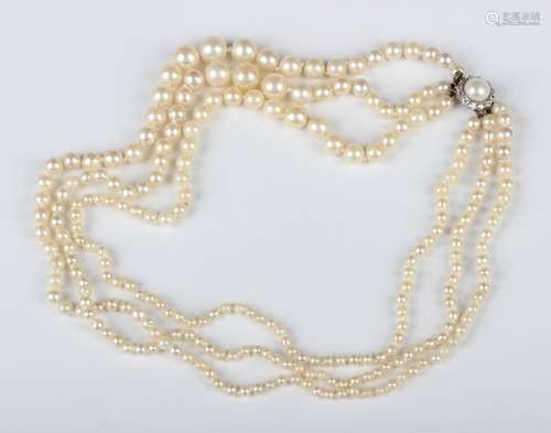 A three row necklace of graduated cultured pearls on a cultu...