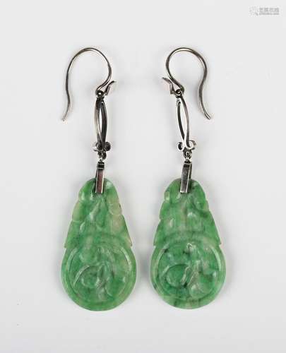 A pair of Chinese white gold mounted jade pendant earrings