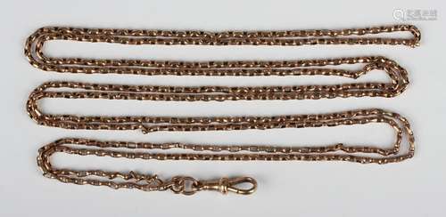 A gold two row oval link long guard chain