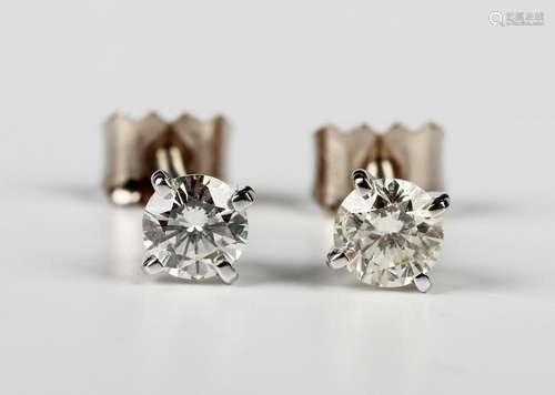 A pair of white gold and diamond single stone earstuds