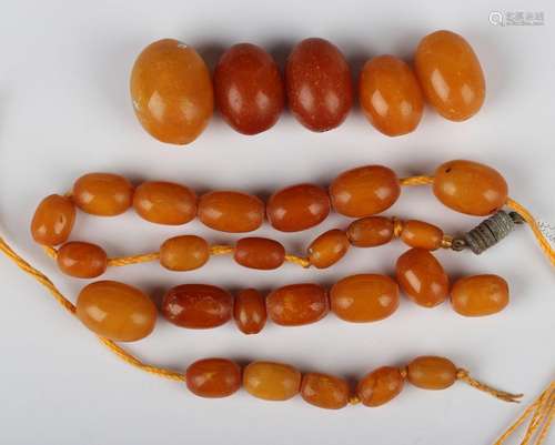 A single row necklace of thirty oval varicoloured butterscot...