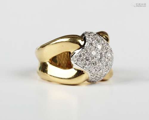 A gold and diamond ring in a quatrefoil shaped cluster desig...