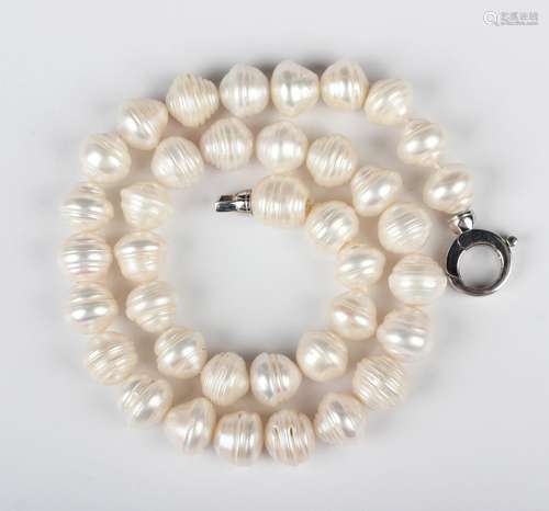 A single row necklace of freshwater cultured pearls on a .92...