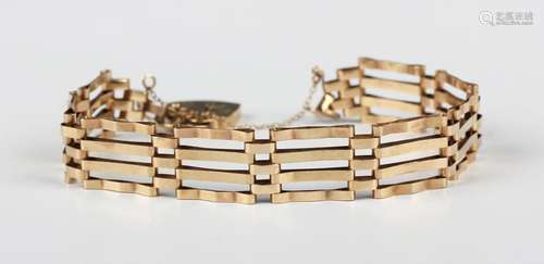 A 9ct gold bar and oval link gate bracelet on a gold heart s...