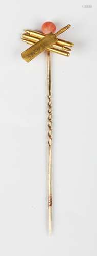 A gold and coral stickpin in the form of a cricket bat and s...