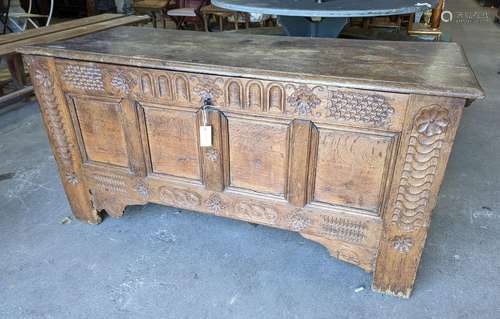 A large 17th century oak panelled coffer, length 147cm, dept...