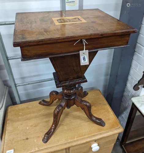 A Victorian walnut trumpet work table, the hinged top inset ...