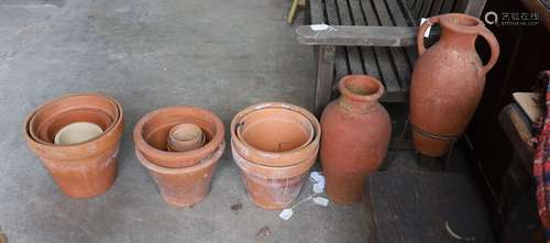 Two Greek style terracotta garden urns, one with iron stand,...