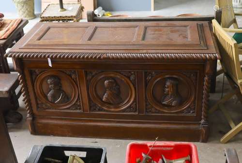 A 17th century style walnut cassone carved with busts in rel...