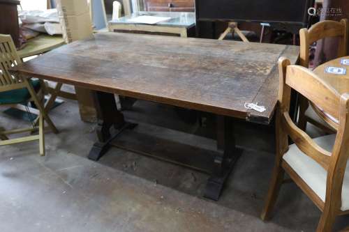 A rectangular oak cleated planked top refectory dining table...