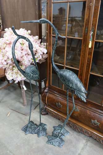 A pair of bronzed metal crane garden ornaments, larger heigh...