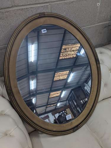 An Edwardian oval gilt framed wall mirror, width 72cm, heigh...