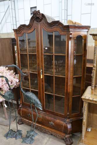 A 19th century Dutch glazed walnut two door vitrine. W 150cm...