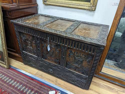 An 18th century oak mule chest with later carved decoration,...