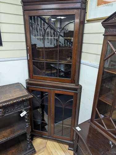 An Edwardian mahogany glazed standing corner cabinet, fitted...