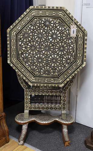 A Damascusware and mother of pearl inlaid octagonal tilt top...