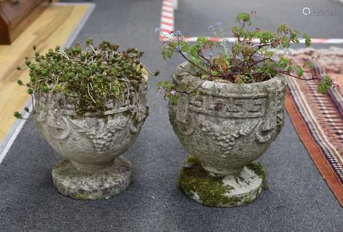 A pair of small reconstituted stone circular garden planters...