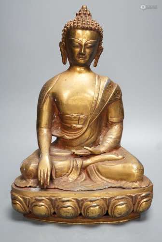 A gilt brass seated figure of Buddha - 38cm high