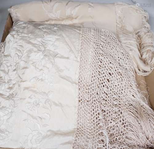 A 19th century cream embroidery on cream silk shawl together...