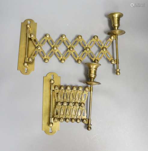 A pair of brass concertina action candlesticks