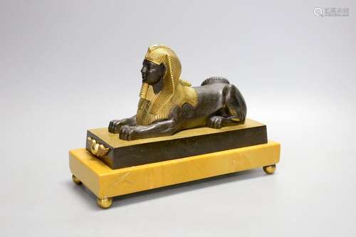 A parcel gilt bronze model of a sphinx on a Siena marble bas...