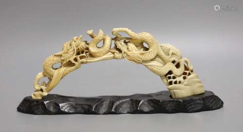 A Japanese boars tusk carving of two confronting dragons, Me...