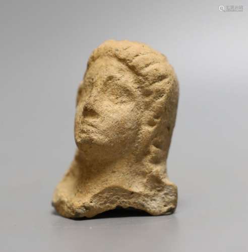 An antiquity terracotta figure head,8cms high.