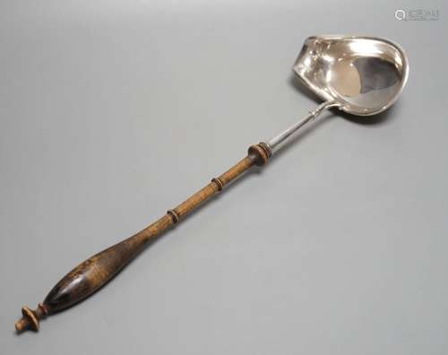 A Swedish? white metal punch ladle, with turned wooden handl...