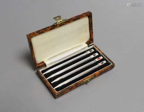 A cased set of four engine turned sterling and enamel bridge...