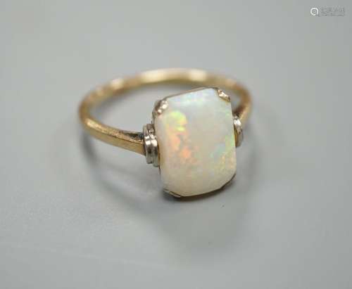 A 9ct and emerald cut white opal set ring, size R, gross wei...