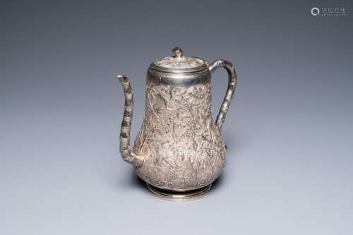 A Chinese silver teapot with birds among blossoming branches...