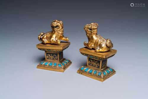 A pair of Chinese gilt bronze Buddhist lions on champleve en...