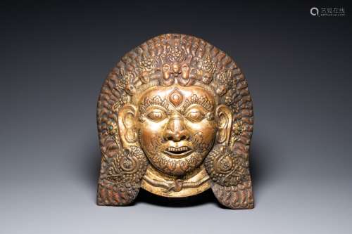 A large Tibetan gilt copper repousse mask of Bhairava, Tibet...