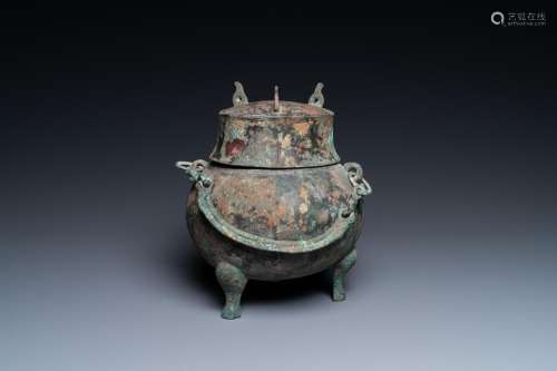 A Chinese bronze ritual tripod 'houlou' wine vessel and cove...