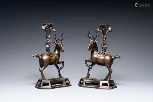 A pair of Chinese bronze deer-shaped candlesticks, Kangxi/Qi...