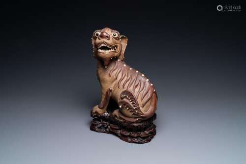 A Chinese Yixing stoneware dog on wooden stand, 19th C